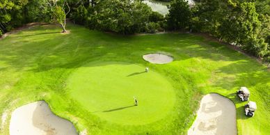 Aerial view of a manicured golf course green at a private club