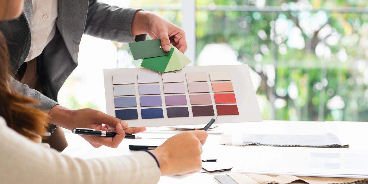 Two people reviewing color swatches for a design project.