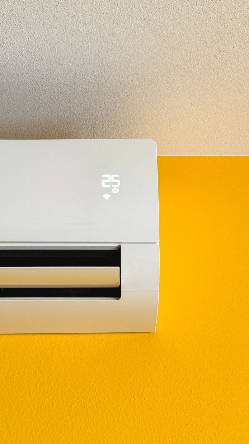 Air conditioner cooling a room, showing 25 degrees Celsius on the digital display