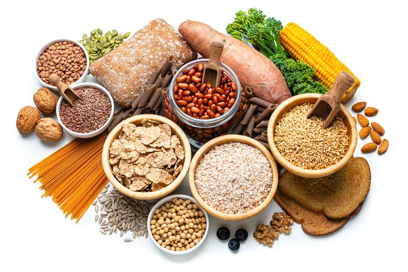 Group of food with high content of good carbohydrates and dietary fiber for a healthy eating and dieting. Sources of healthy carbs to include in the diet. High angle view, white background