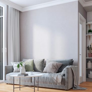 Cozy modern living room with gray sofa and pillows.