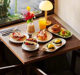 Vibrant breakfast spread with drinks in a cozy setting.