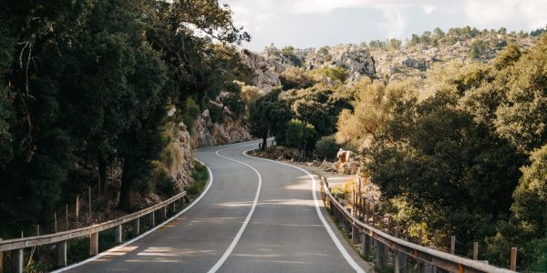 Winding road through a forested mountainous landscape.