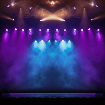 Empty stage with colorful spotlights and smoke effect.
