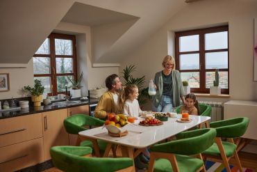 Family enjoying breakfast together in a cozy kitchen.