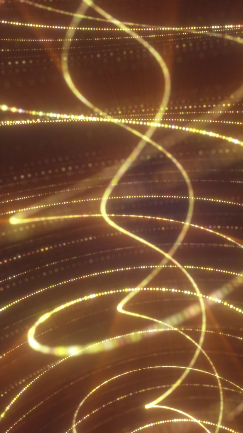 Warm golden light trails with bokeh dots and glowing curves, forming an elegant abstract motion background for luxury, celebration, and energy themes.