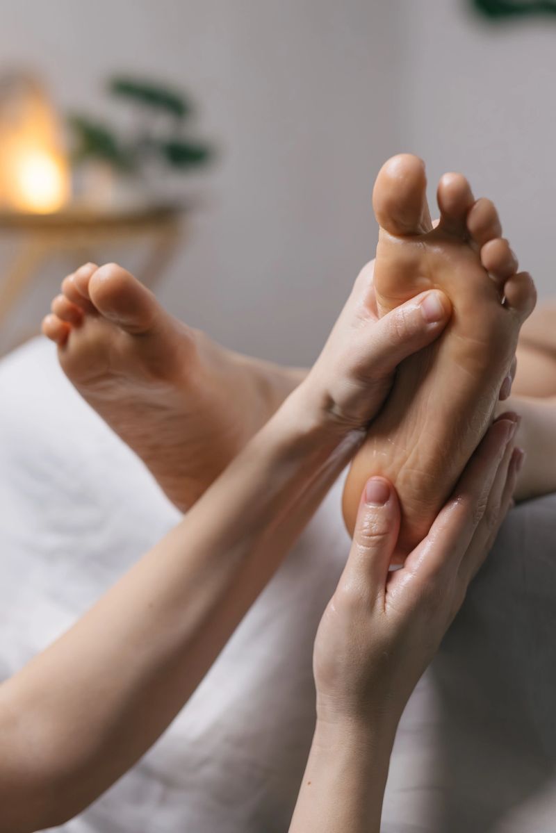 Close-up of professional foot massage in modern spa center. Wellness therapy, relaxation and body care concept.