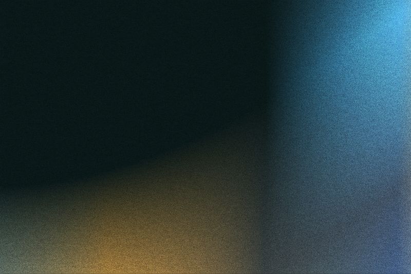 Abstract grainy gradient background in dark blue, black, and orange colors with motion blur