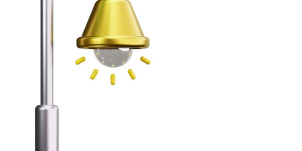 Close-up of a modern golden streetlight with glowing light.