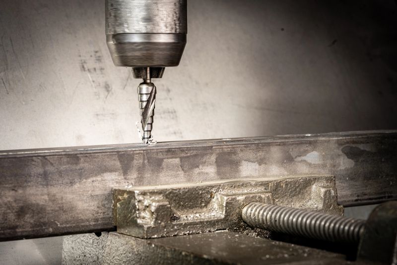 Close-up of an industrial CNC milling machine precisely drilling a metal component within a manufacturing facility. The automated process showcases advanced technology in metal fabrication. Metal shavings flying and the machine operating with precision and efficiency
