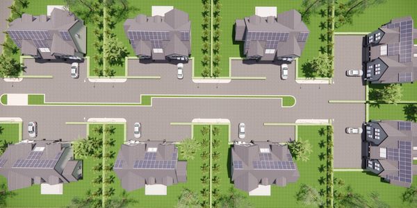 Aerial view of suburban homes with solar panels.