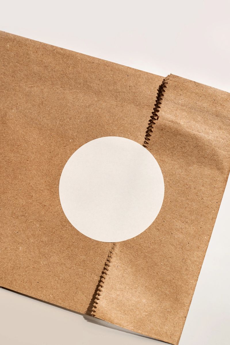 Close-up of eco-friendly kraft paper bag with blank circle logo design.