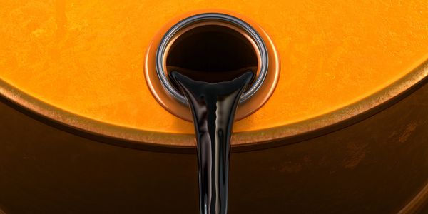 Close-up of dark liquid pouring into a container.