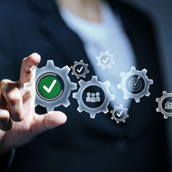 Businessman interacting with digital gears icons representing success.