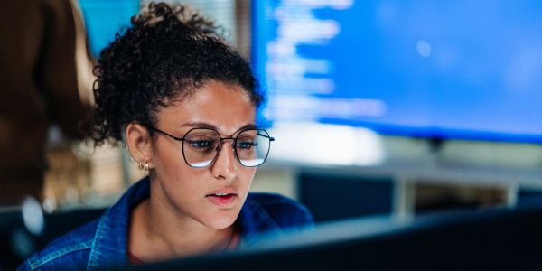 Woman focused on computer screen.