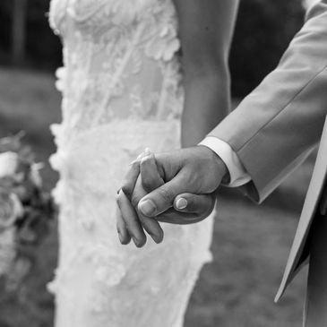 Couple holding hands at their wedding.