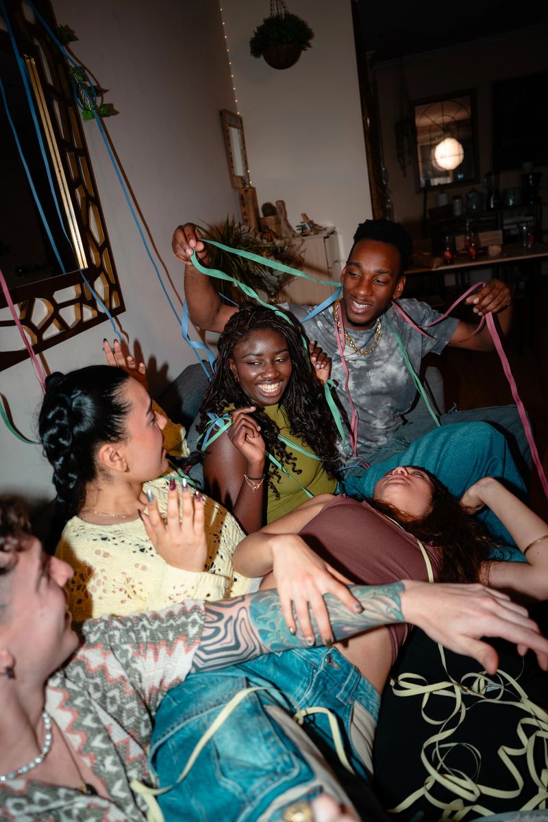 Diverse group of gen z friends celebrating a lively house party, creating fun memories while throwing colorful streamers