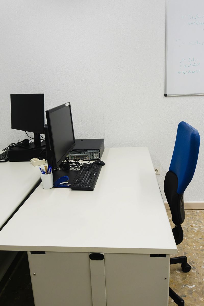 Various workstations within an IT office, with desks and chairs arranged for comfortable working, copy of space