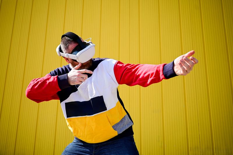 Man interacting with virtual reality simulation, wearing a modern VR headset