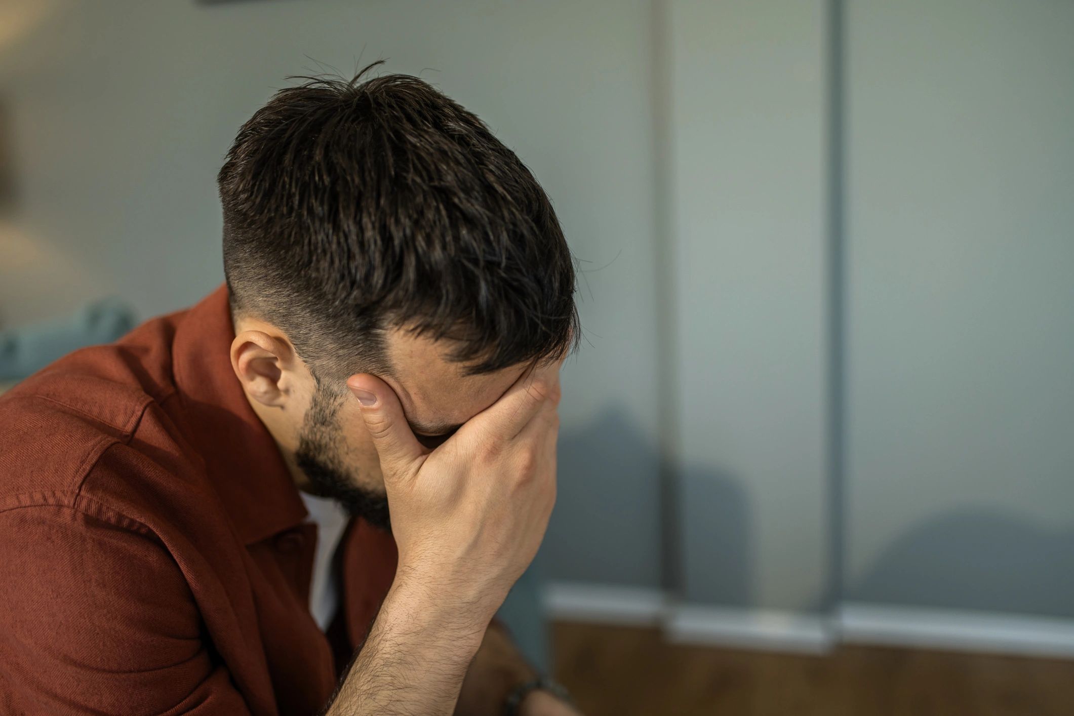 Man hanging his head