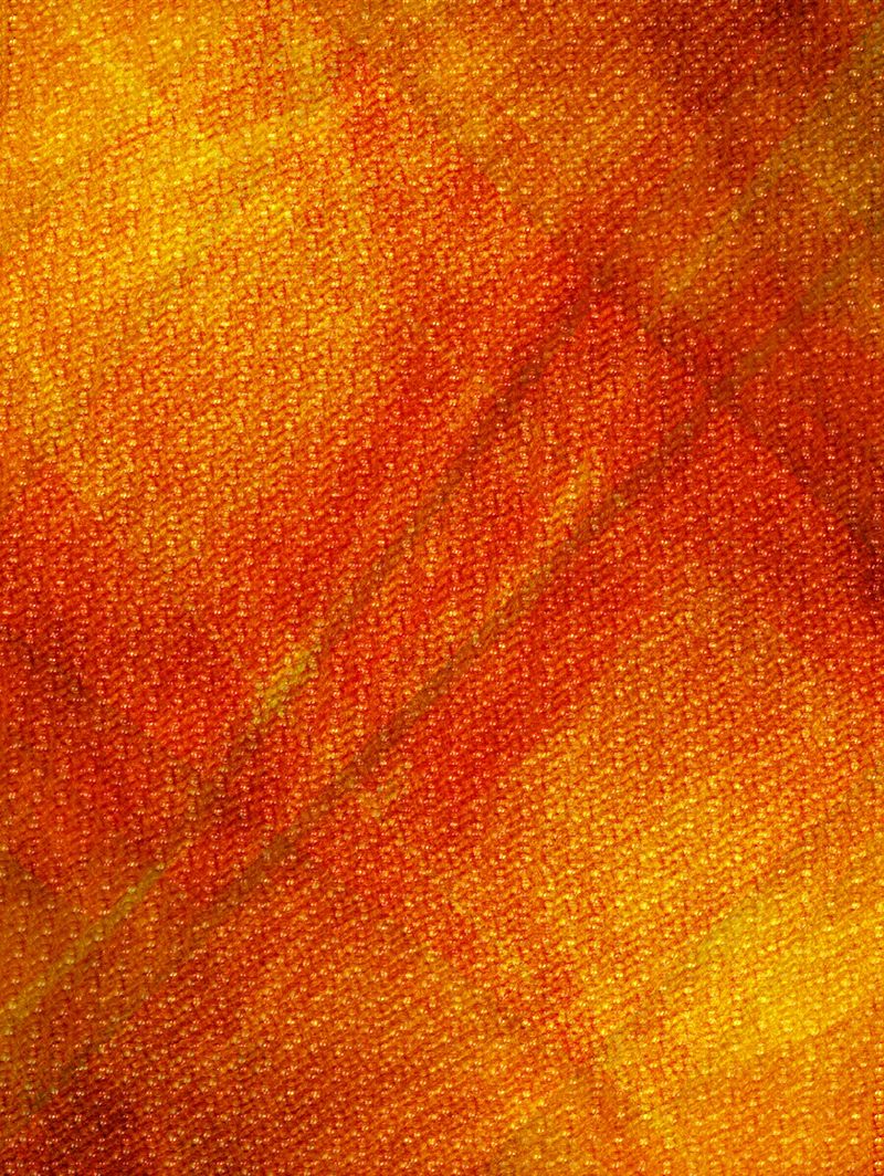 Warm orange and gold fabric texture with painterly gradients and woven surface detail, ideal as an abstract background for design, art, web, and print projects conveying warmth and energy.