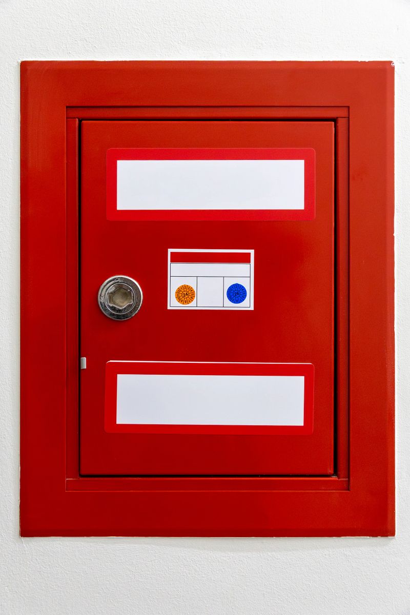 Red fire hose cabinet with inspection sticker. High quality photo