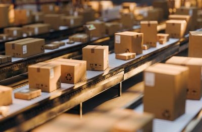 Conveyor belts moving cardboard boxes in a warehouse.