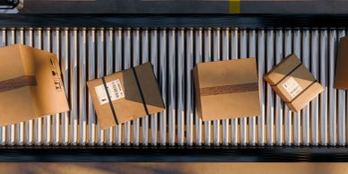 Packages on a conveyor belt in a warehouse.
