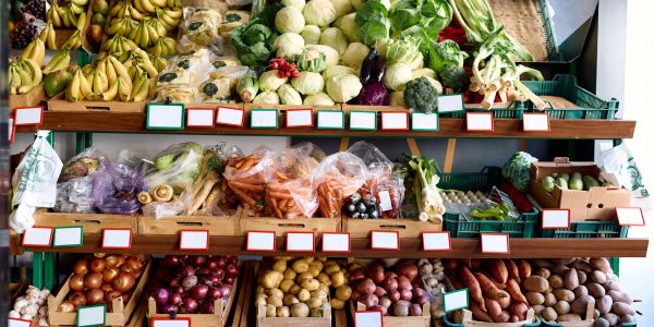 Fresh vegetables and fruits displayed in a market.
