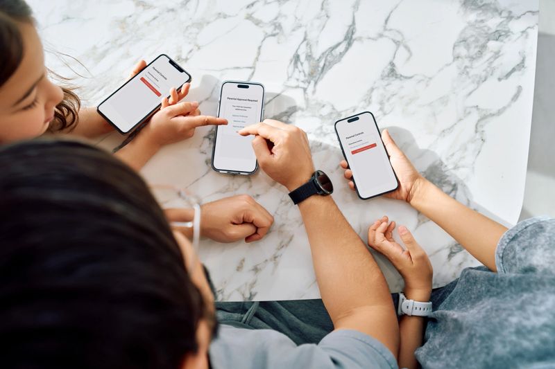 Family interacting with smartphones showing parental approval requests for app usage, illustrating digital safety and screen time management