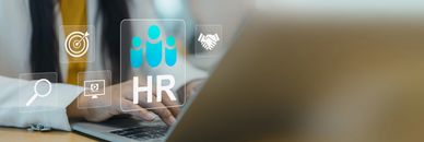 Person using laptop with HR icons floating above.