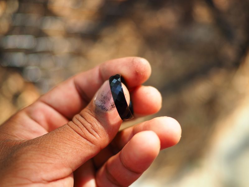 a men's faceted black ceramic polished band