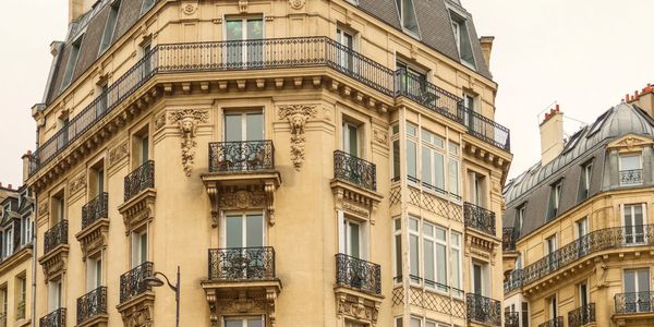 Elegant Parisian building with ornate balconies and classic architecture.