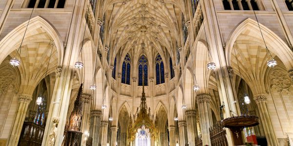 Interior of a grand Gothic cathedral with high vaulted ceilings.