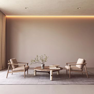 Minimalist living room with two beige armchairs and a wooden coffee table.