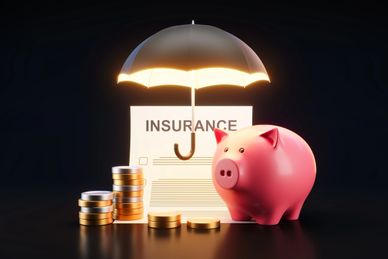 Piggy bank, insurance form, coins, and glowing umbrella symbolizing financial protection.