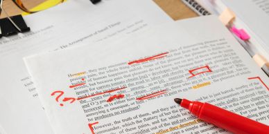Annotated academic paper with red pen and question marks.