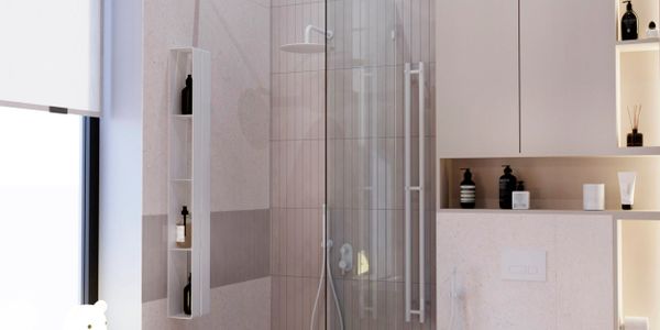 Modern bathroom with glass shower and built-in shelves.
