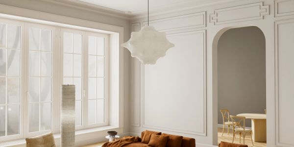 Bright, elegant living room with large windows and warm-toned furniture.