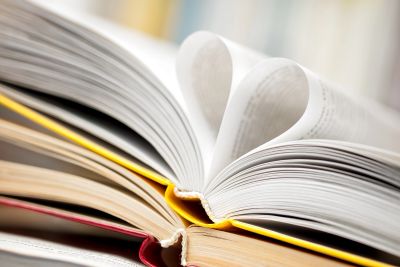 Pages of an open book forming a heart shape.