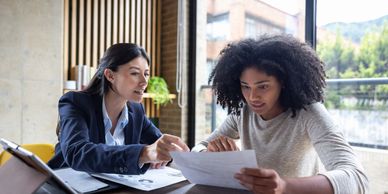 Business owners reviewing financial reports and business performance