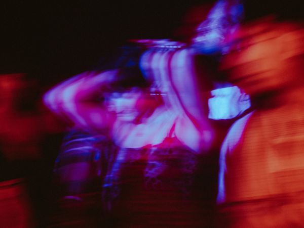 Blurred colorful light trails create an abstract motion effect.