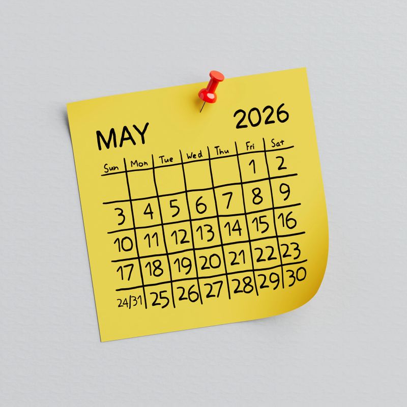Yellow Note Paper with May of 2026 Year. May Handwritten Calendar and Thumbtack Pin on a white background. 3d Rendering