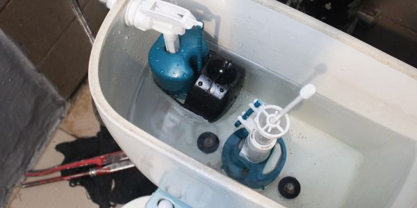 Inside view of a toilet tank showing its components and water level.