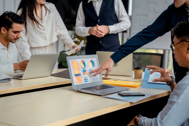 A diverse finance team discussing investment strategies. A strategic planning meeting among business professionals.