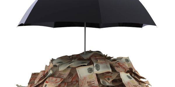 Black umbrella shielding a pile of currency notes.