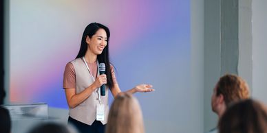 Woman giving a presentation to an audience.