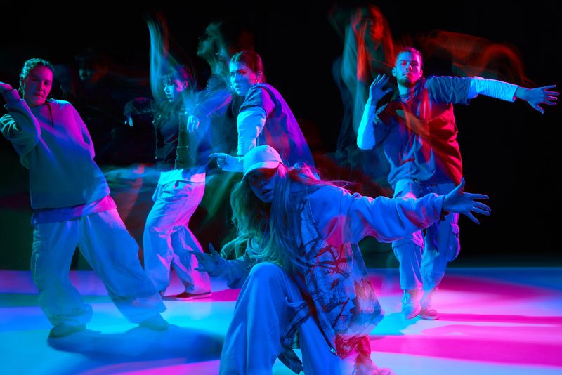 Hip hop dance crew performing choreography with neon lighting and motion blur for music promotion, advertising campaigns, nightlife branding and youth lifestyle marketing