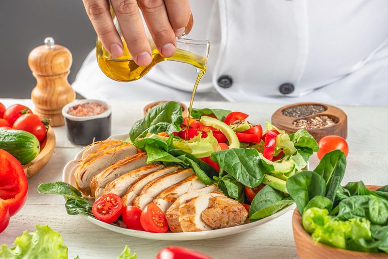 Grilled chicken meat and fresh vegetable salad. Chef cooking. Concept healthy and balanced eating.