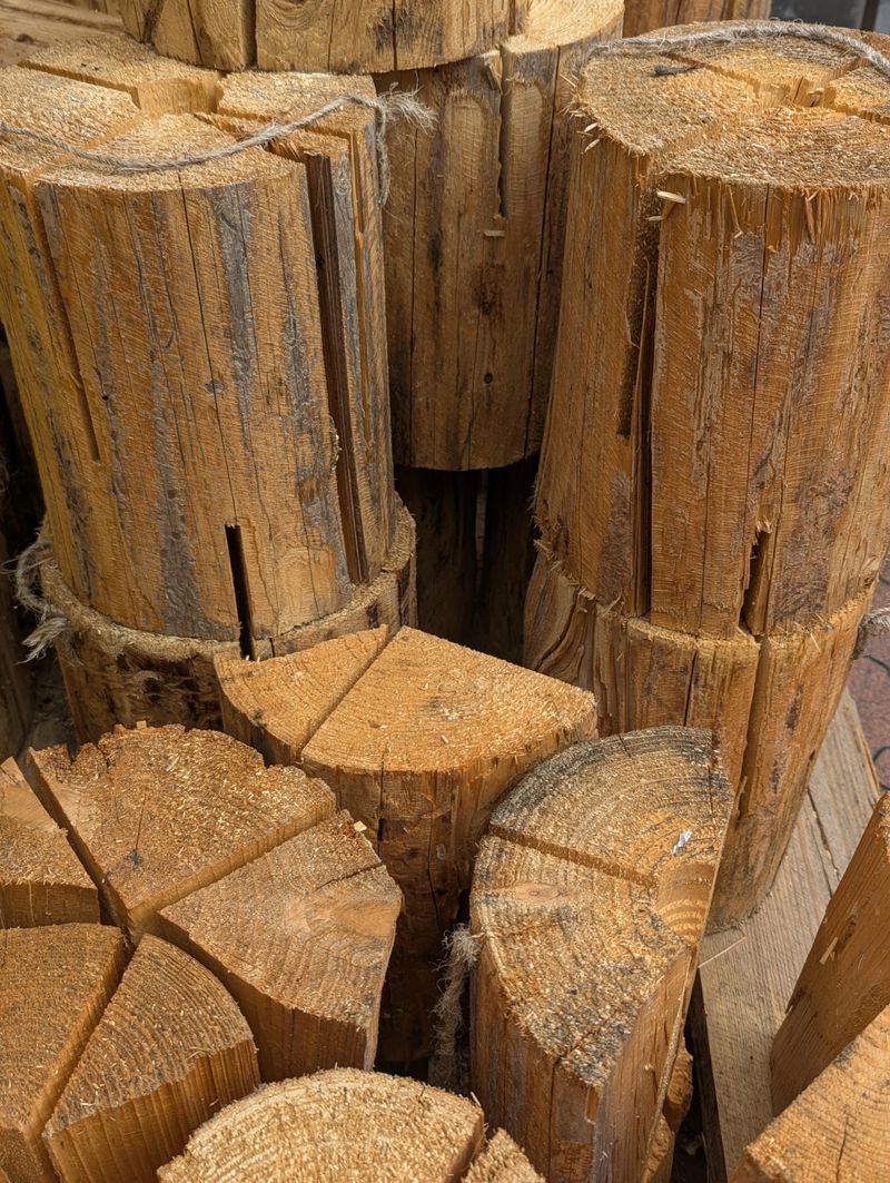 Stacked Split Logs For Firewood, Rustic Pile With Rough Bark And Sawdust, Prepped By Woodcutter For Winter Stove, Closeup Texture Showing Grain And Growth Rings, Warm Earthy Tones
